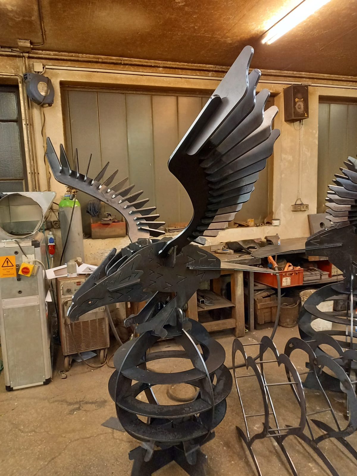 Adler-Skulptur aus Stahl mit ausgebreiteten Schwingen in der Werkstatt